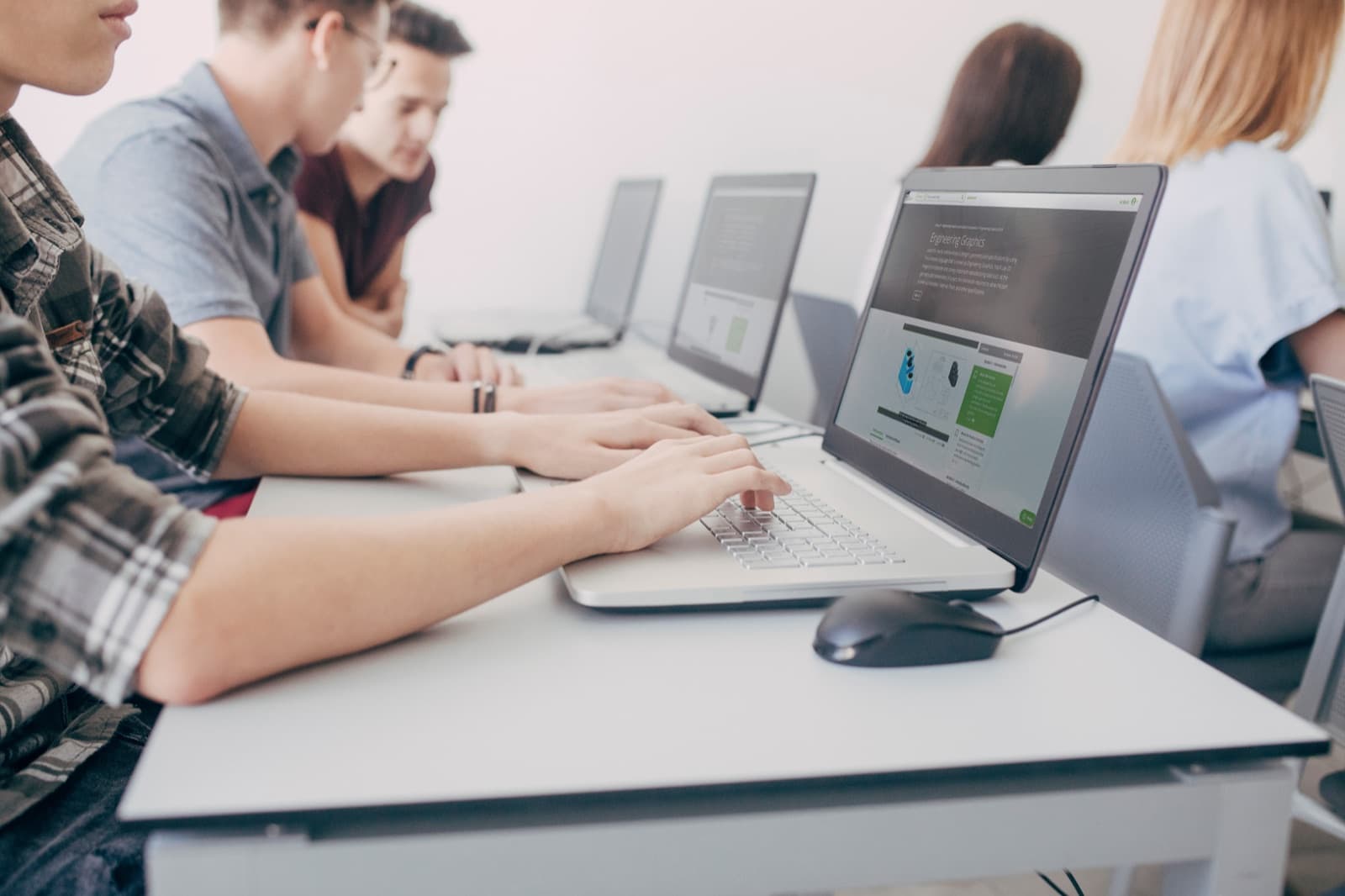 Students working on engineering graphics in the SolidProfessor platform