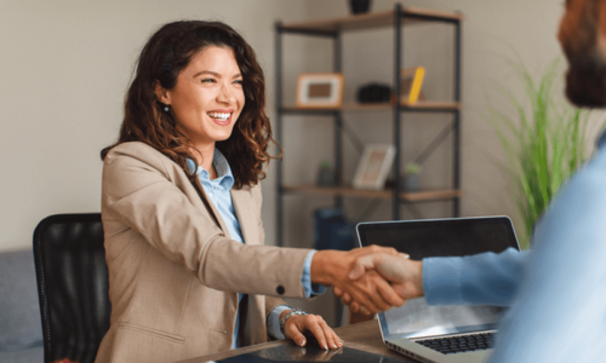 Professional shaking hands with an employer after an interview.