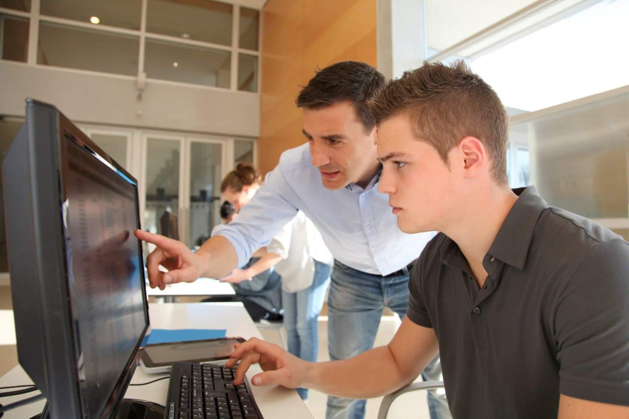 Student and teacher in a computer lab
