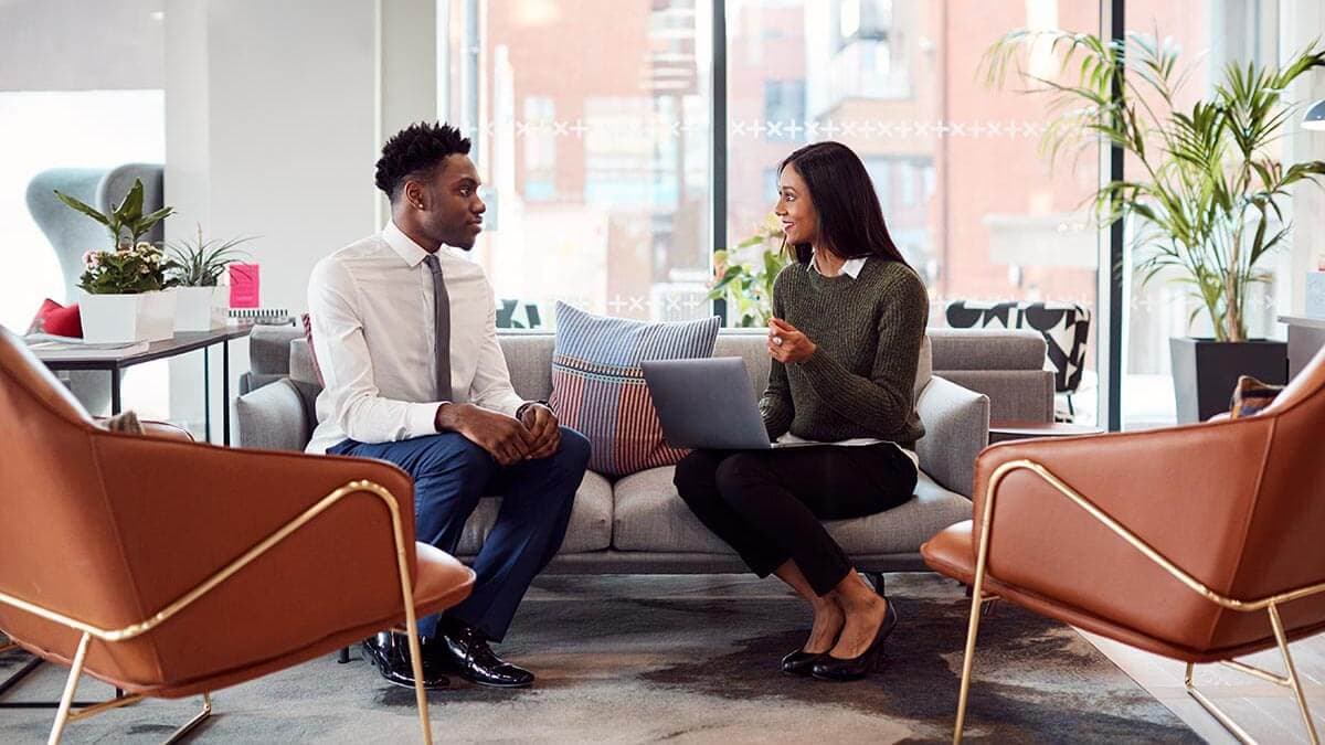 A candidate and hiring manager at a manufacturing job interview