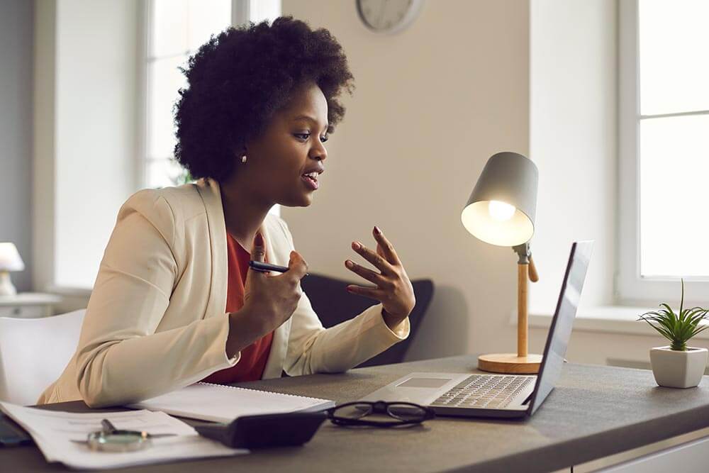 A woman is asking questions about the role in a virtual interview